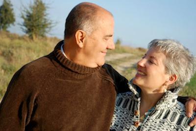 older man and woman smiling at one another