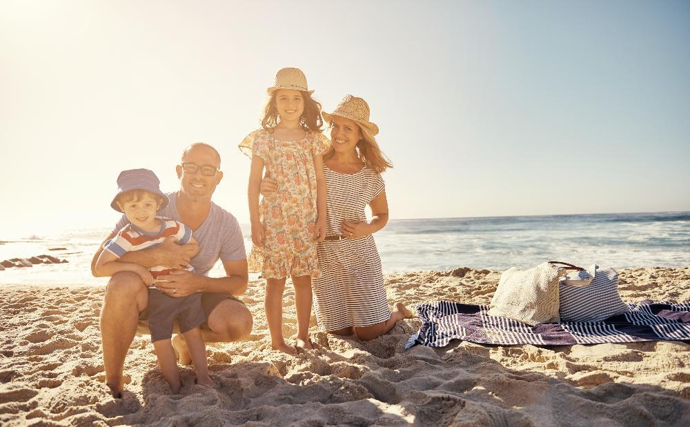 family of four on beach l dentist clifton hill vic