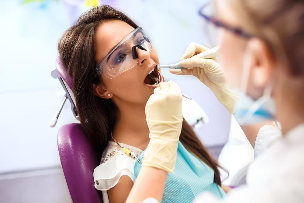 woman receiving dental exam l dentist clifton hill