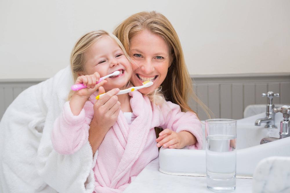 mother and daughter brushing teeth l dentist near northcote