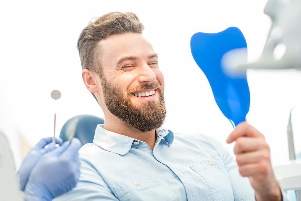 man sitting in dental exam chair | gum disease clifton hill vic