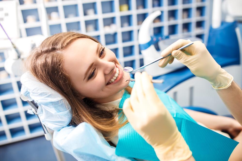 woman receiving dental exam | periodontal disease treatment clifton hill