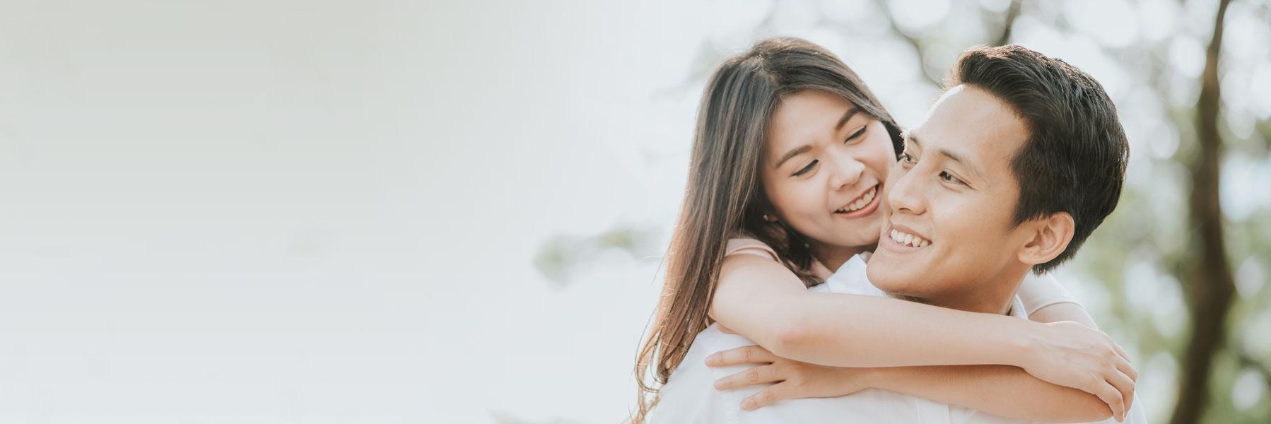 young couple hugging outside l dentist northcote 