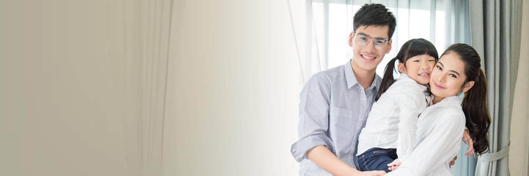 young family smiling & hugging l dental implants thornbury