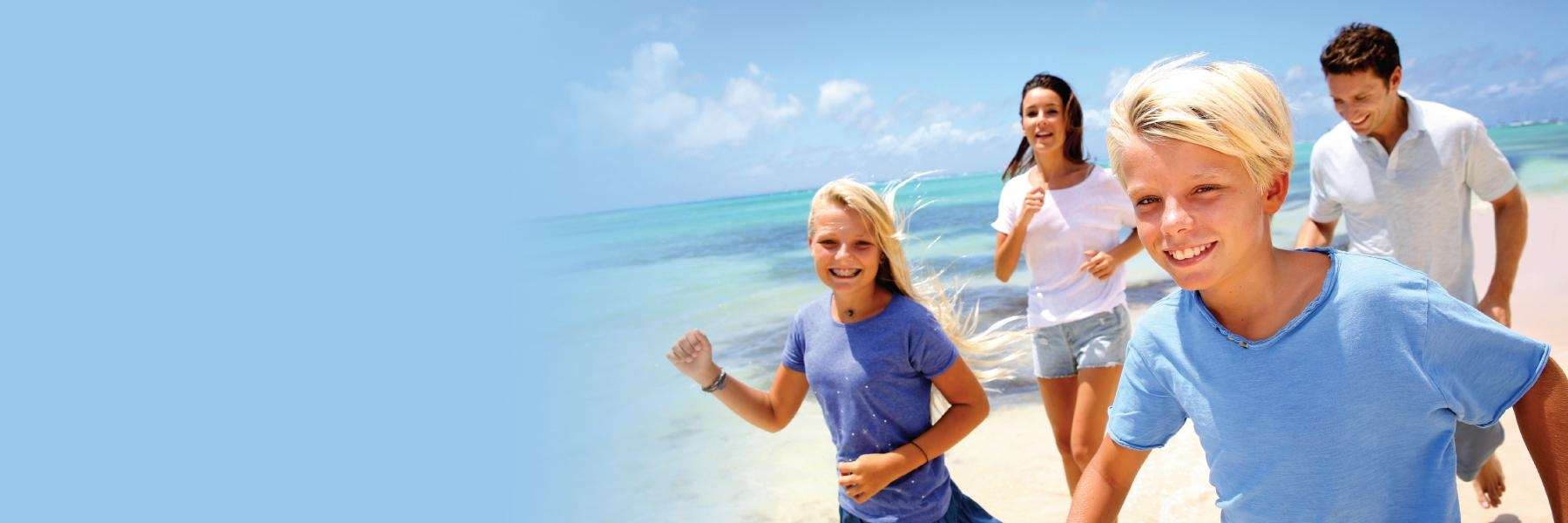 A family running on the beach
