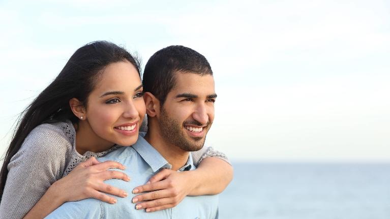 young couple smiling at beach l dentist thornbury