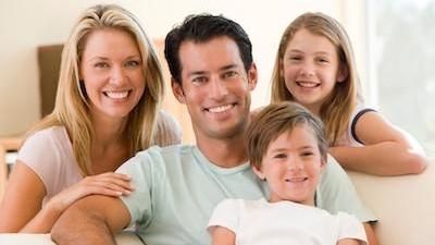 family of four hugging l dentist near me clifton hill