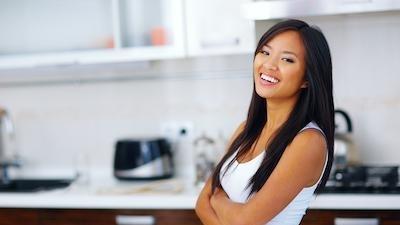 woman wearing tank top smiling l dental implants thornbury