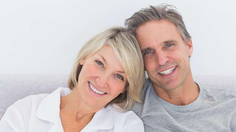 A smiling couple with over dentures in clifton hill