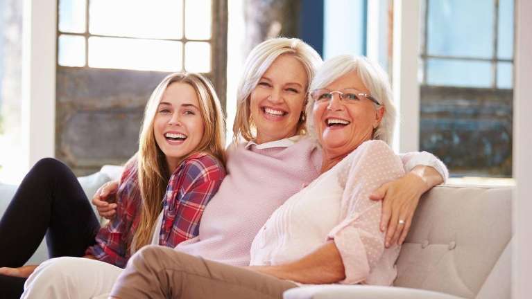 A laughing family on the couch | general dentist clifton hill