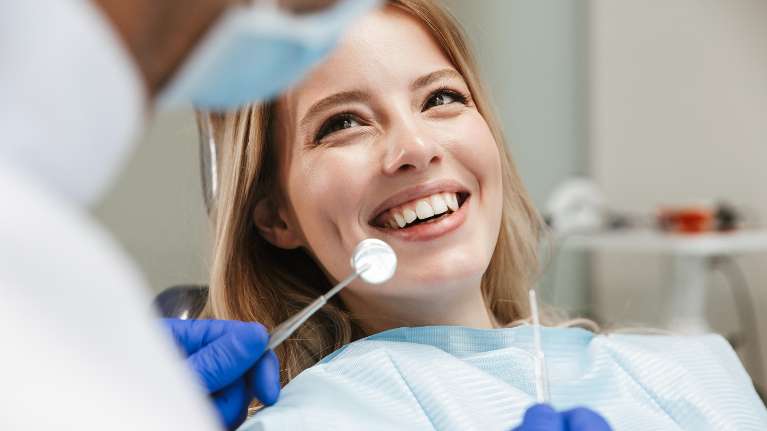 A woman getting a dental checkup | oral health therapist Clifton Hill