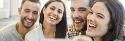 group of four young people smiling l dentist near me