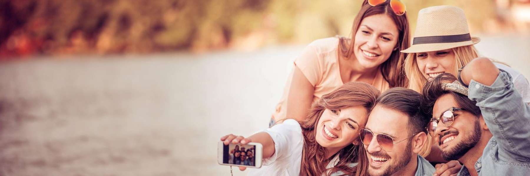 A group of friends posing by the lake