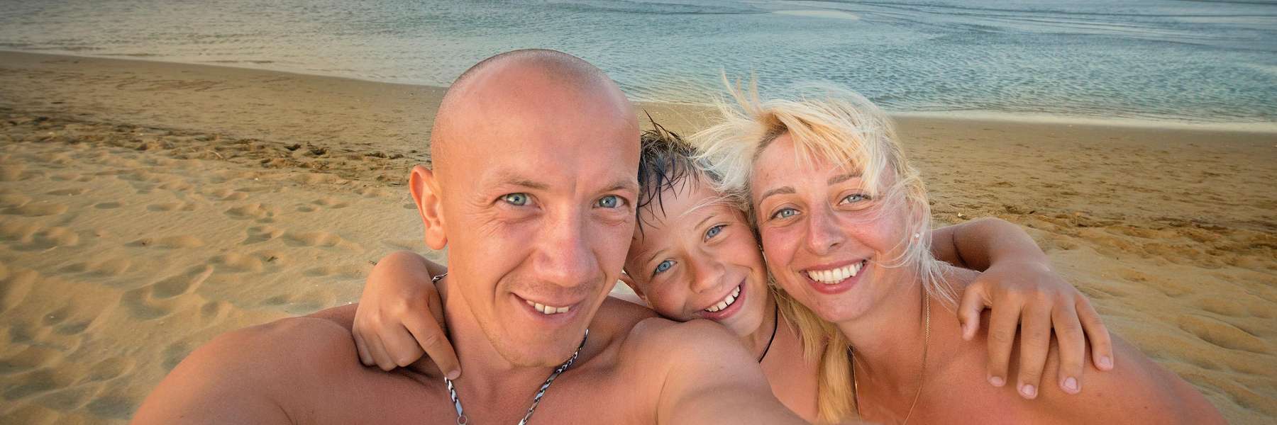 family of three on beach | clifton hill dentist