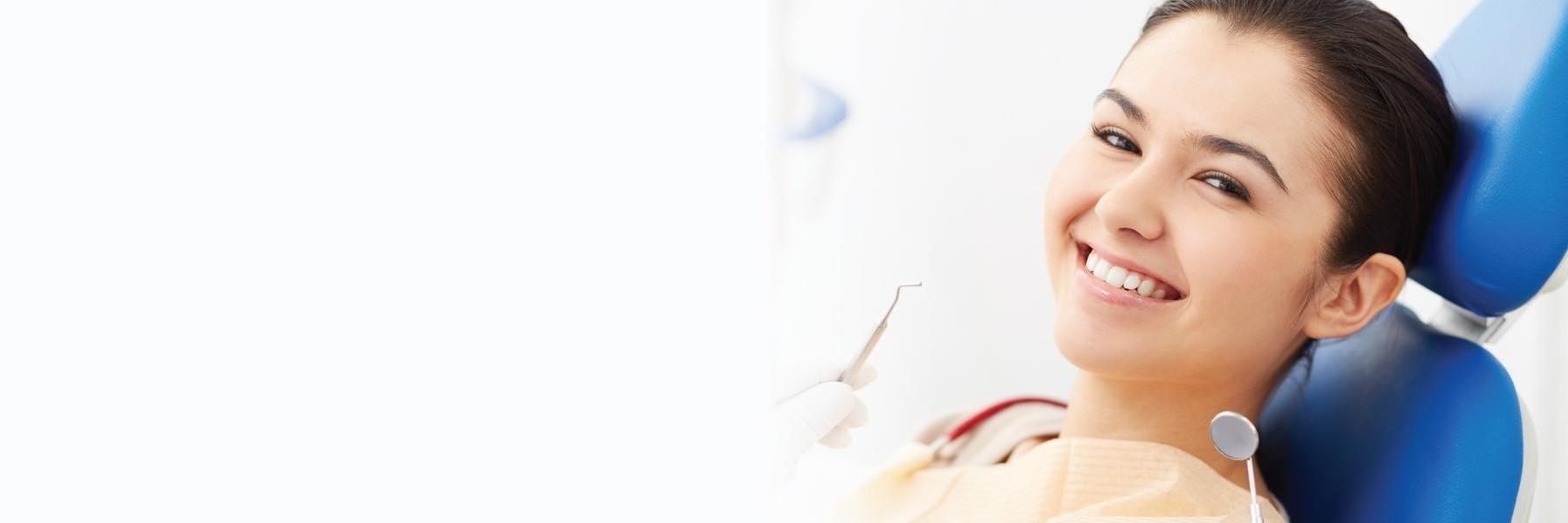 Woman smiling in dental chair | teeth whitening clifton hill