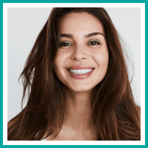 A woman with straightened teeth smiling