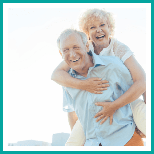 A laughing wife sitting on her husbands' back